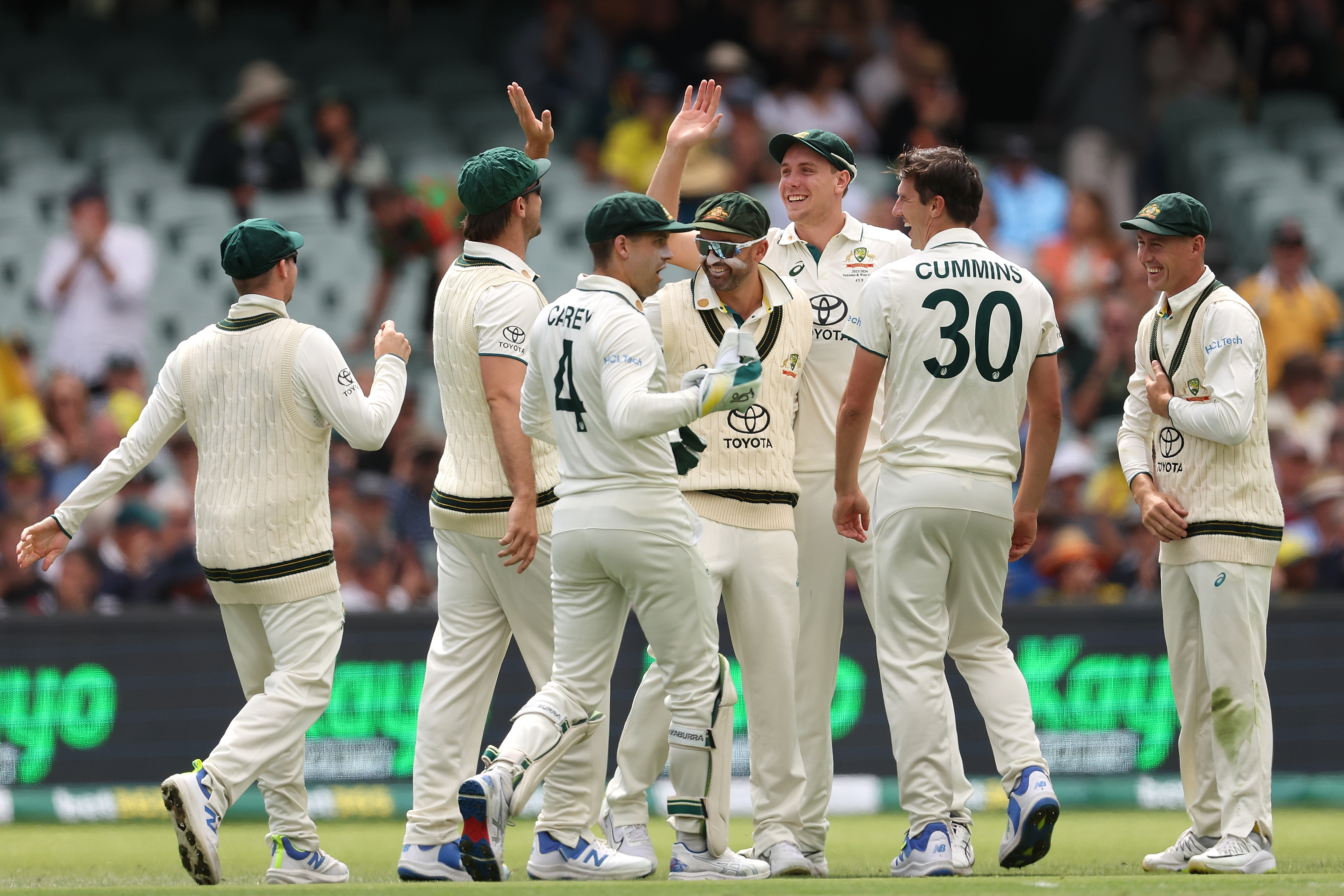 mens cricket team celebrating a win on the cricket pitch of adelaide oval